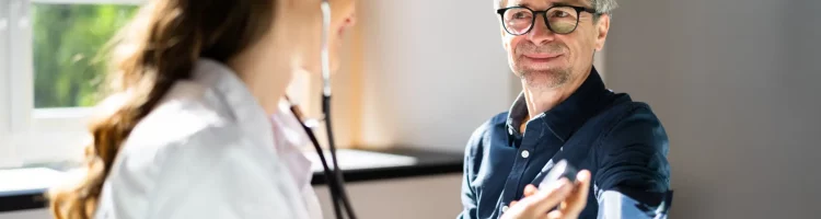 Doctor Measuring Blood Pressure Of Male Patient